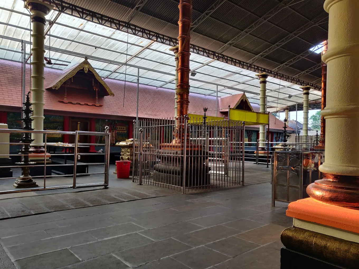 Devotees offering prayers and lighting lamps in the courtyard of Chelamattam Sreekrishnaswami Temple