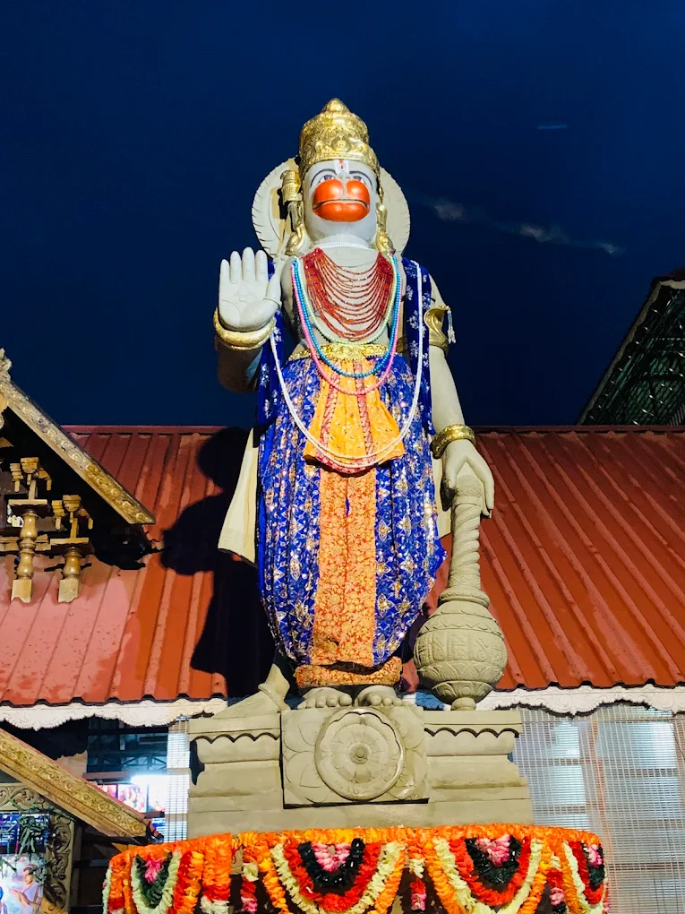 Devotees offering prayers and lighting lamps in the courtyard of Sri Datta Anjaneya Temple