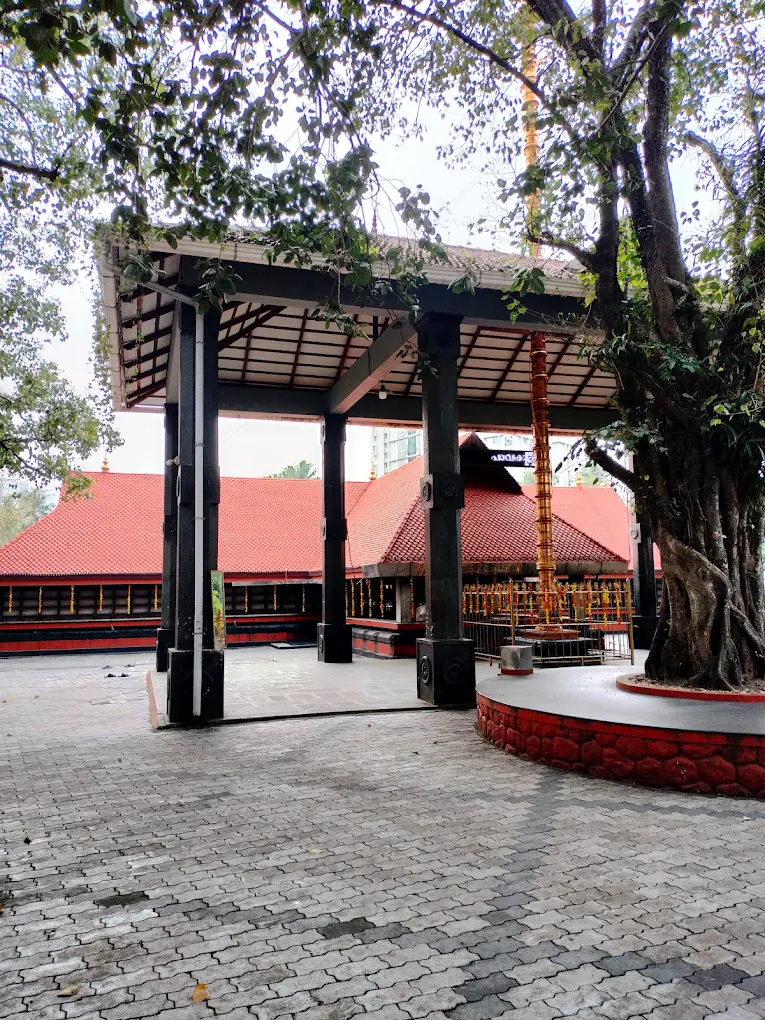 Pavakulam Sree Mahadeva Temple surrounded by lush greenery and serene temple pond.